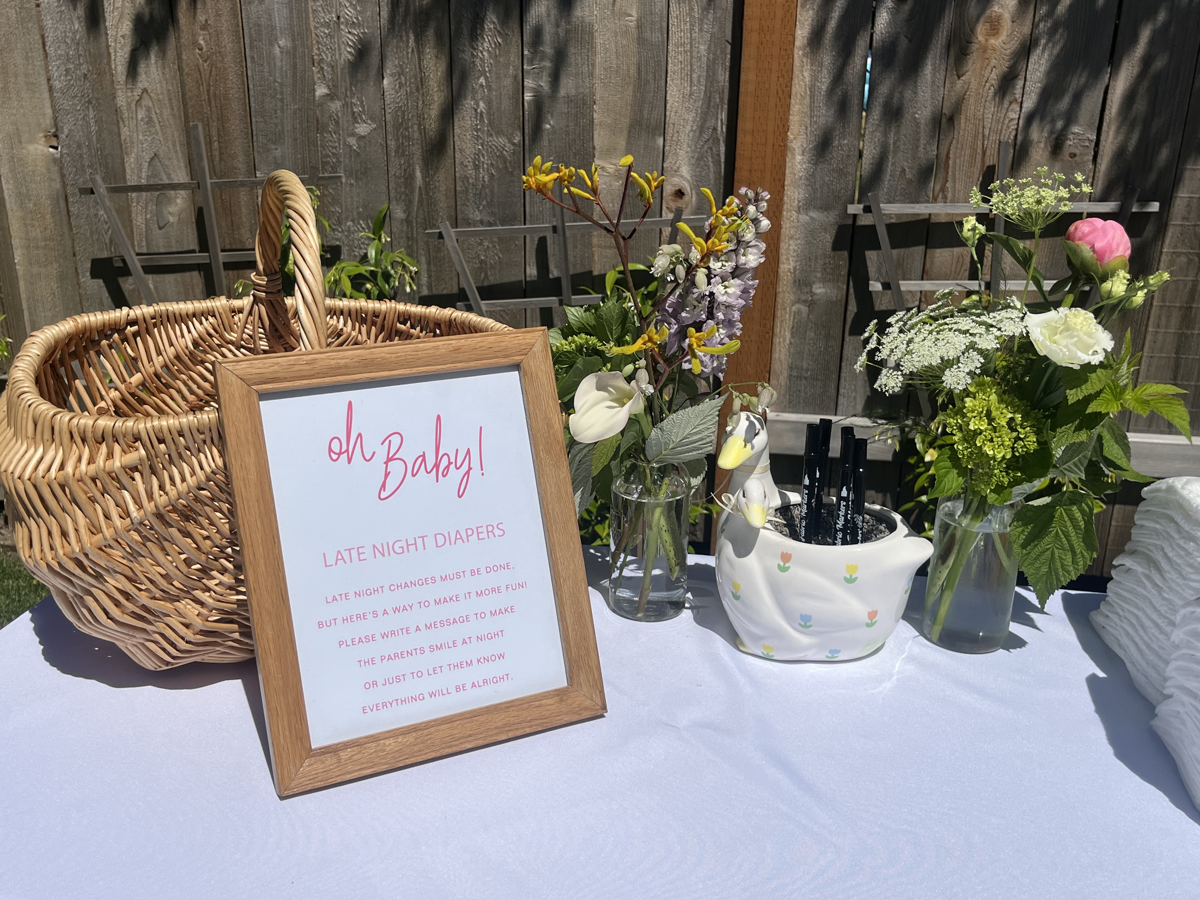 Baby shower table with festive styling and arrangements